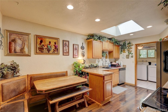 233 Nome St, Aurora, CO 80010 - kitchen featuring washer and clothes dryer, dishwasher, a skylight, electric range oven, and light countertops
