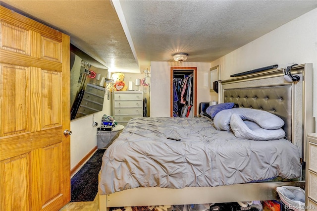 233 Nome St, Aurora, CO 80010 - bedroom featuring a closet, a textured ceiling, and a walk in closet