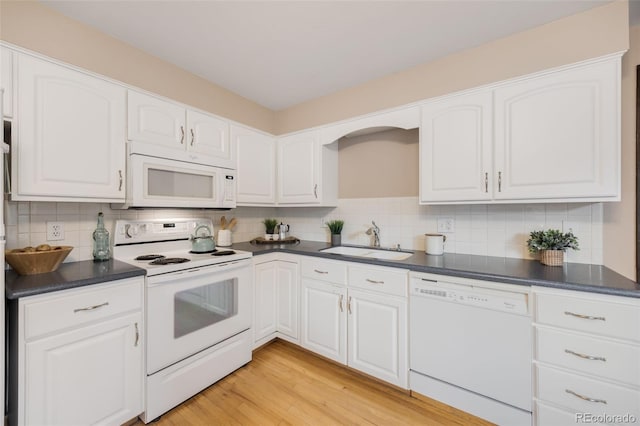 1185 Yank St, Golden, CO 80401 - kitchen with white appliances, a sink, dark countertops, and backsplash