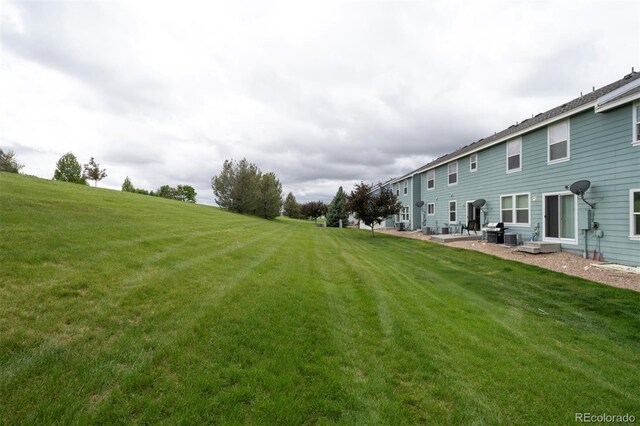 19249 E 58th Ave Unit D, Denver, CO 80249 - view of green lawn with a patio area