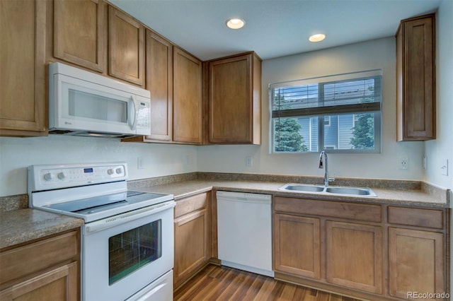 19249 E 58th Ave Unit D, Denver, CO 80249 - kitchen with white appliances, a sink, dark wood-type flooring, brown cabinetry, and recessed lighting