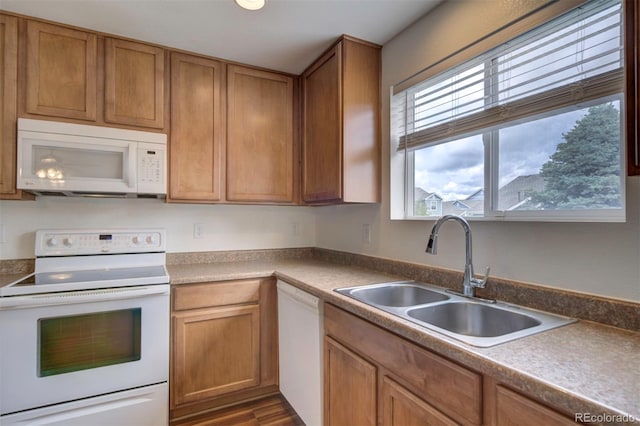 19249 E 58th Ave Unit D, Denver, CO 80249 - kitchen featuring white appliances, a sink, and brown cabinets