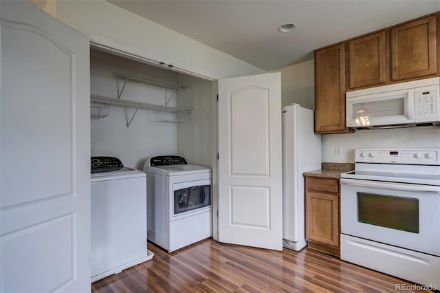 19249 E 58th Ave Unit D, Denver, CO 80249 - kitchen with white appliances, dark wood-style flooring, washer and clothes dryer, brown cabinetry, and recessed lighting