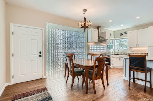 5461 S Youngfield Ct, Littleton, CO 80127 - dining space featuring light wood-type flooring, a chandelier, recessed lighting, and baseboards