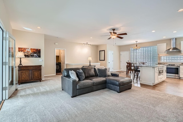 5461 S Youngfield Ct, Littleton, CO 80127 - living room featuring a ceiling fan, light colored carpet, recessed lighting, baseboards, and washer / dryer