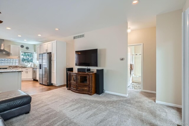 5461 S Youngfield Ct, Littleton, CO 80127 - living area featuring light colored carpet, baseboards, and recessed lighting