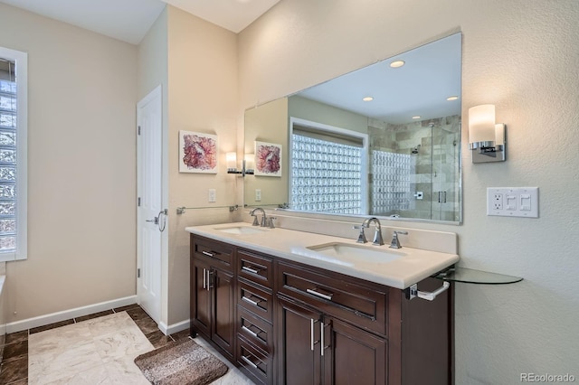 5461 S Youngfield Ct, Littleton, CO 80127 - bathroom with a shower stall, double vanity, and baseboards