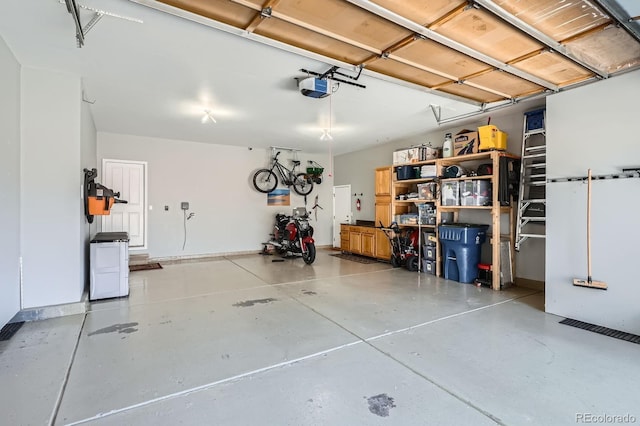5461 S Youngfield Ct, Littleton, CO 80127 - garage featuring a garage door opener and baseboards
