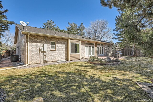 5461 S Youngfield Ct, Littleton, CO 80127 - back of property featuring cooling unit, a patio area, and brick siding