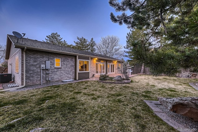 5461 S Youngfield Ct, Littleton, CO 80127 - back of house featuring cooling unit and brick siding