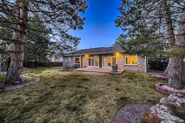 5461 S Youngfield Ct, Littleton, CO 80127 - back of house featuring a patio and brick siding