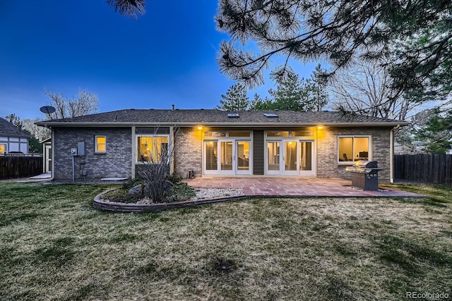 5461 S Youngfield Ct, Littleton, CO 80127 - rear view of property featuring a patio and brick siding