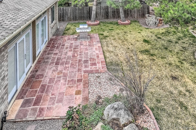 5461 S Youngfield Ct, Littleton, CO 80127 - exterior view of a fenced backyard and a shingled roof