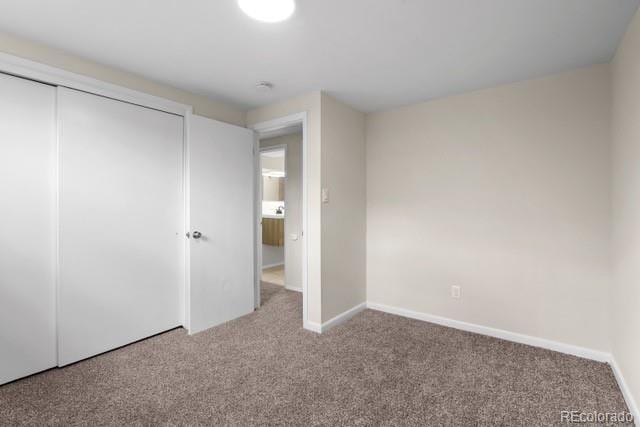 unfurnished bedroom featuring a closet and carpet floors