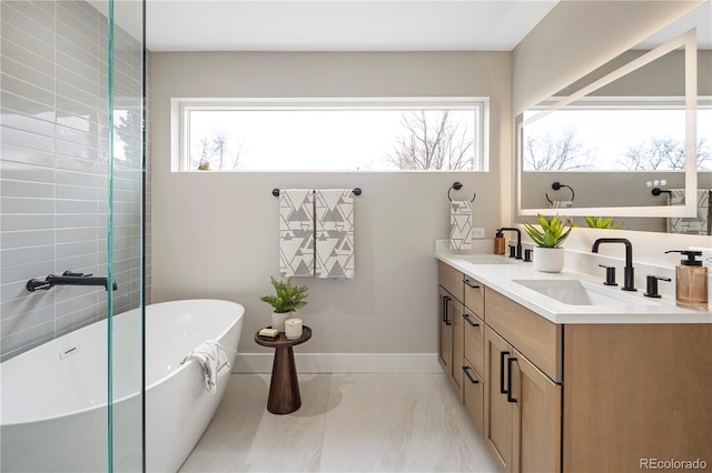 bathroom featuring vanity and a washtub