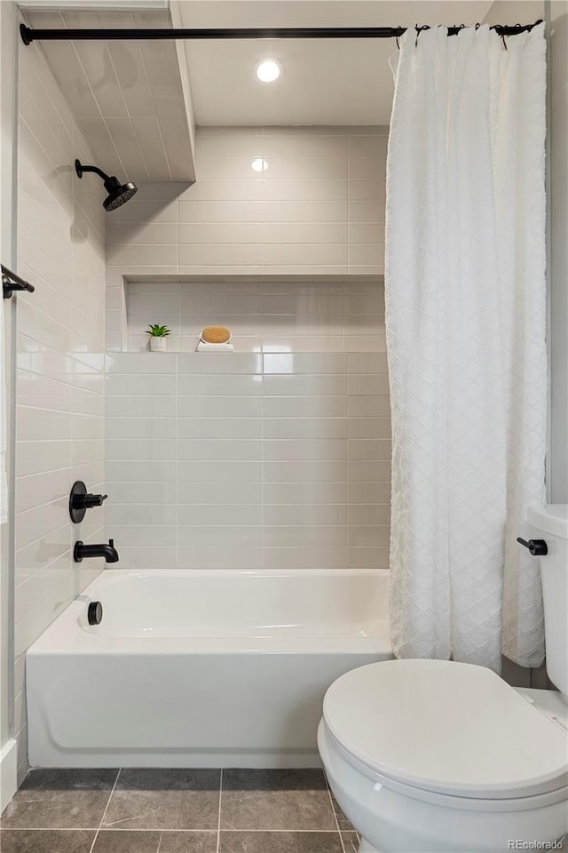 bathroom featuring tile patterned flooring, shower / bath combo, and toilet