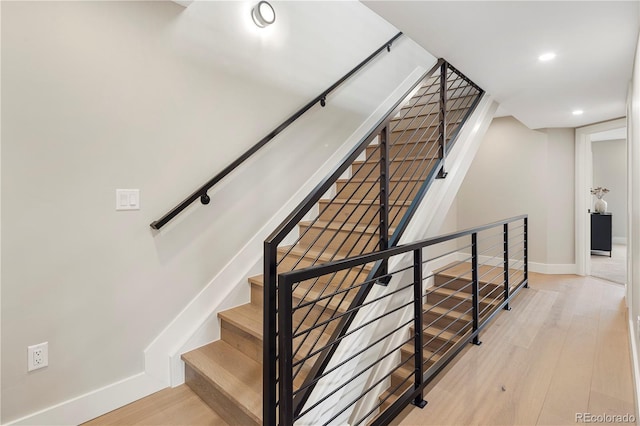 stairs with hardwood / wood-style flooring