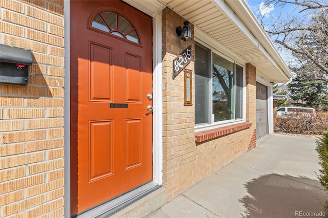 view of exterior entry with brick siding