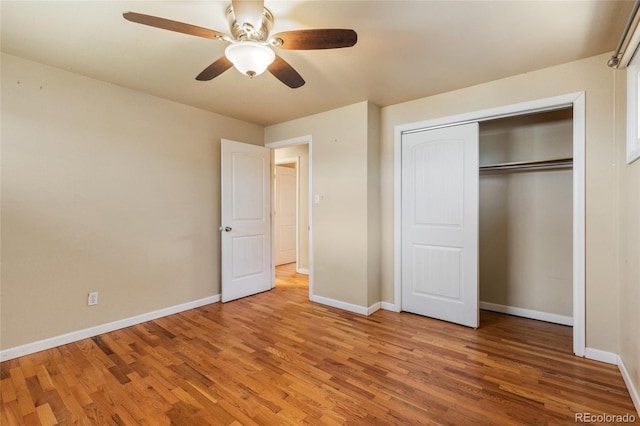 unfurnished bedroom with a closet, baseboards, a ceiling fan, and light wood finished floors