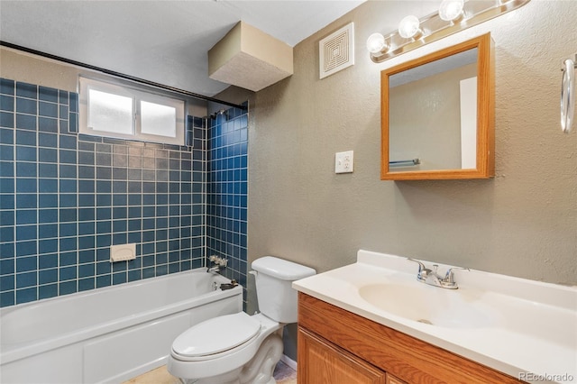 bathroom featuring vanity, visible vents, shower / tub combination, toilet, and a textured wall