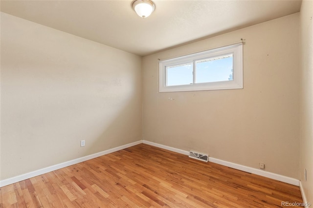 spare room with visible vents, baseboards, and light wood-style floors