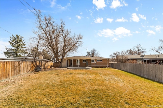 view of yard featuring a patio area and a fenced backyard