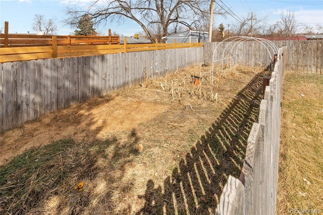 view of yard with a fenced backyard