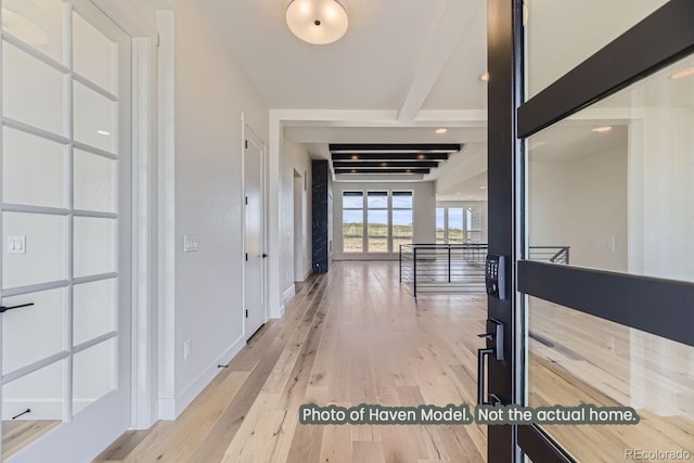 hall with beamed ceiling and light hardwood / wood-style floors