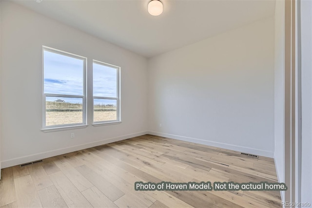 empty room with light hardwood / wood-style flooring