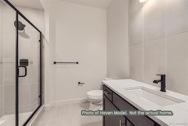 bathroom with tile patterned floors, vanity, toilet, and a shower with shower door