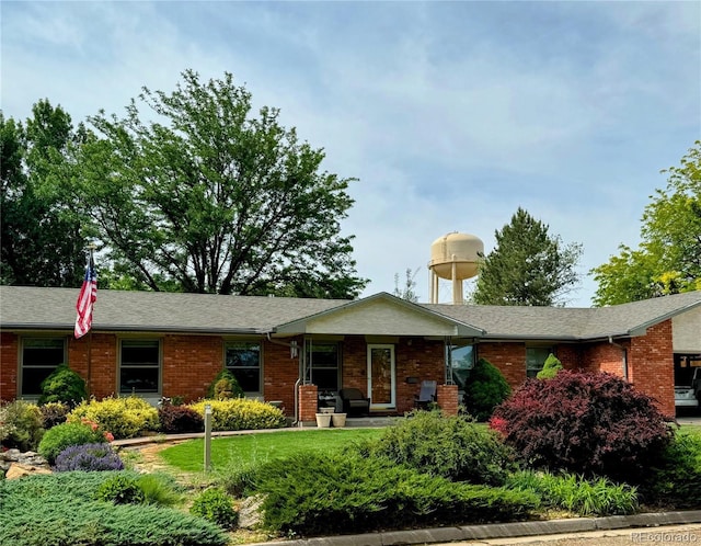 ranch-style home featuring brick siding