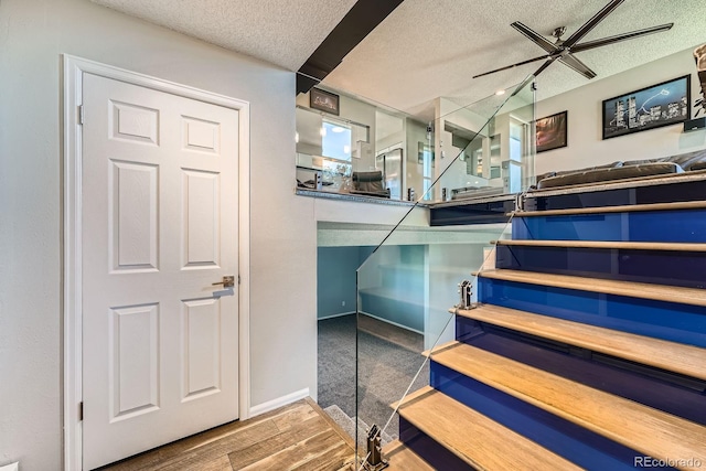15531 E Jewell Pl, Aurora, CO 80013 - staircase featuring a textured ceiling, ceiling fan, and wood finished floors