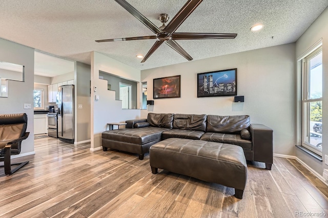 15531 E Jewell Pl, Aurora, CO 80013 - living area with a textured ceiling, light wood-type flooring, ceiling fan, plenty of natural light, and recessed lighting