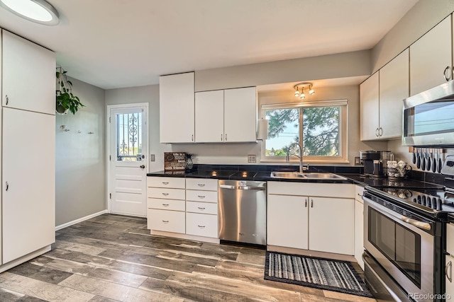 15531 E Jewell Pl, Aurora, CO 80013 - kitchen with stainless steel appliances, a sink, dark wood finished floors, and healthy amount of natural light