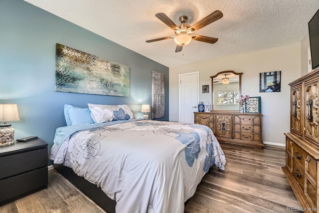 15531 E Jewell Pl, Aurora, CO 80013 - bedroom featuring wood finished floors, a textured ceiling, a ceiling fan, and baseboards