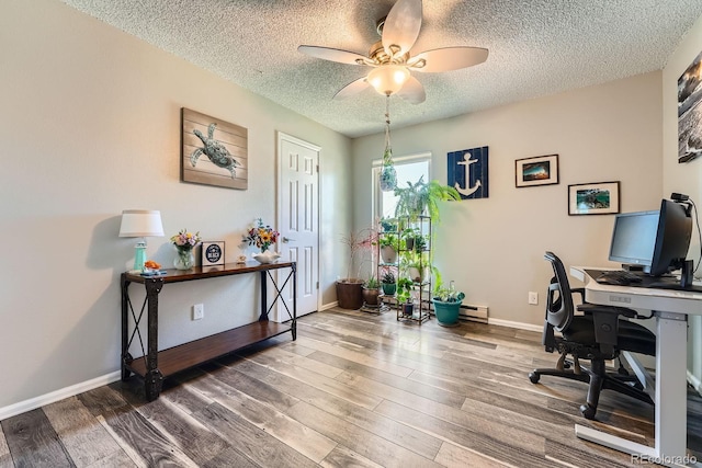15531 E Jewell Pl, Aurora, CO 80013 - office area featuring a textured ceiling, ceiling fan, wood finished floors, a baseboard heating unit, and baseboards