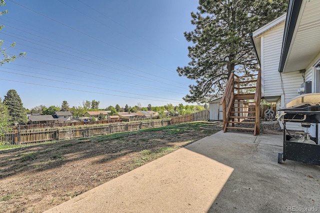 15531 E Jewell Pl, Aurora, CO 80013 - fenced backyard with a patio, stairs, and a residential view