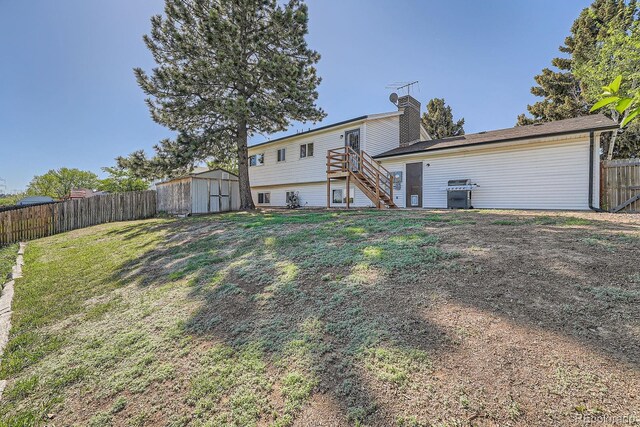 15531 E Jewell Pl, Aurora, CO 80013 - rear view of property with stairway, a storage shed, a chimney, and an outdoor structure