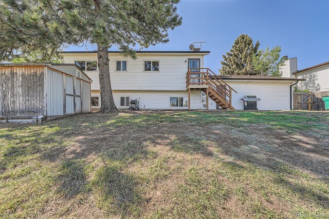 15531 E Jewell Pl, Aurora, CO 80013 - back of house with stairs, an outbuilding, a deck, and a storage unit