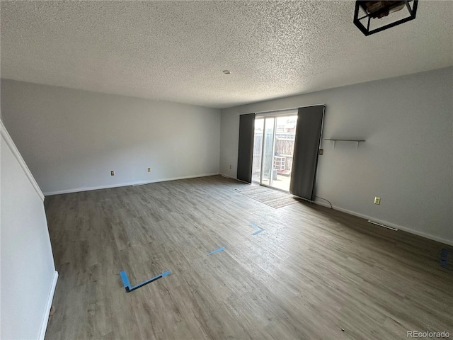 8047 Wolff St Unit H, Westminster, CO 80031 - spare room with wood finished floors, a textured ceiling, and baseboards