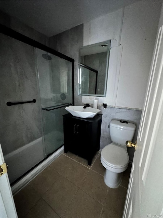 8047 Wolff St Unit H, Westminster, CO 80031 - bathroom with vanity, a stall shower, toilet, and tile patterned floors