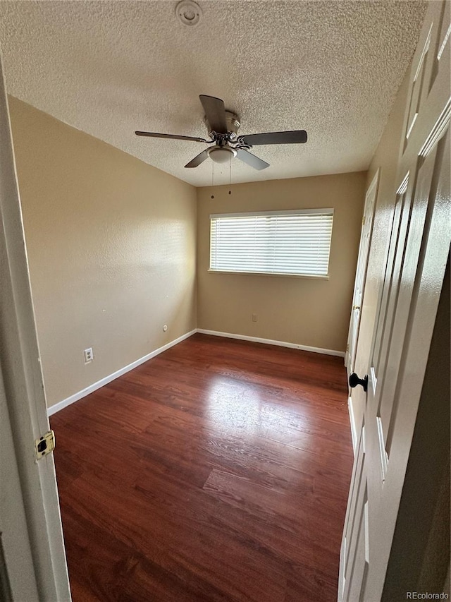 8047 Wolff St Unit H, Westminster, CO 80031 - unfurnished room featuring dark wood-style floors, a ceiling fan, a textured ceiling, and baseboards