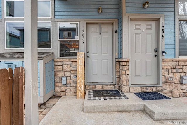 property entrance featuring stone siding