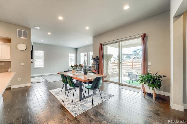 dining space with baseboards, visible vents, dark wood finished floors, and recessed lighting