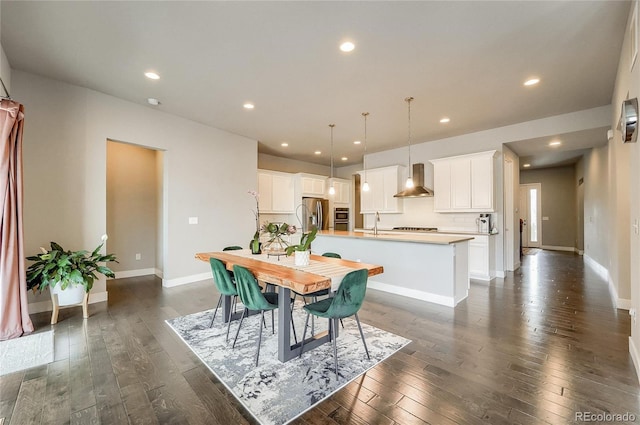 dining area with dark wood-style floors, baseboards, and recessed lighting