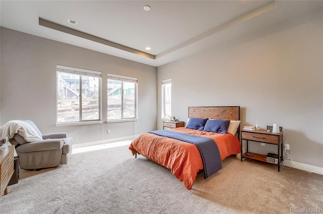 bedroom with recessed lighting, a raised ceiling, carpet flooring, and baseboards