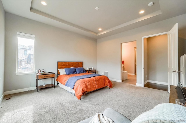 bedroom with baseboards, a tray ceiling, and recessed lighting