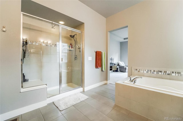 full bath with tile patterned flooring, a shower stall, baseboards, and a bath