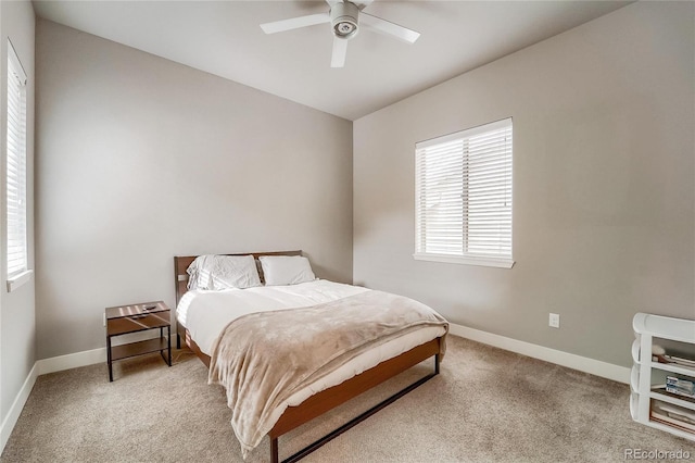 bedroom featuring light carpet, ceiling fan, and baseboards