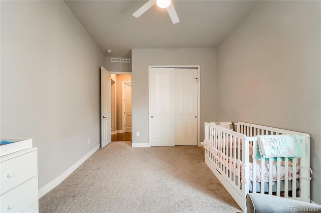 unfurnished bedroom with baseboards, visible vents, a ceiling fan, carpet flooring, and a closet